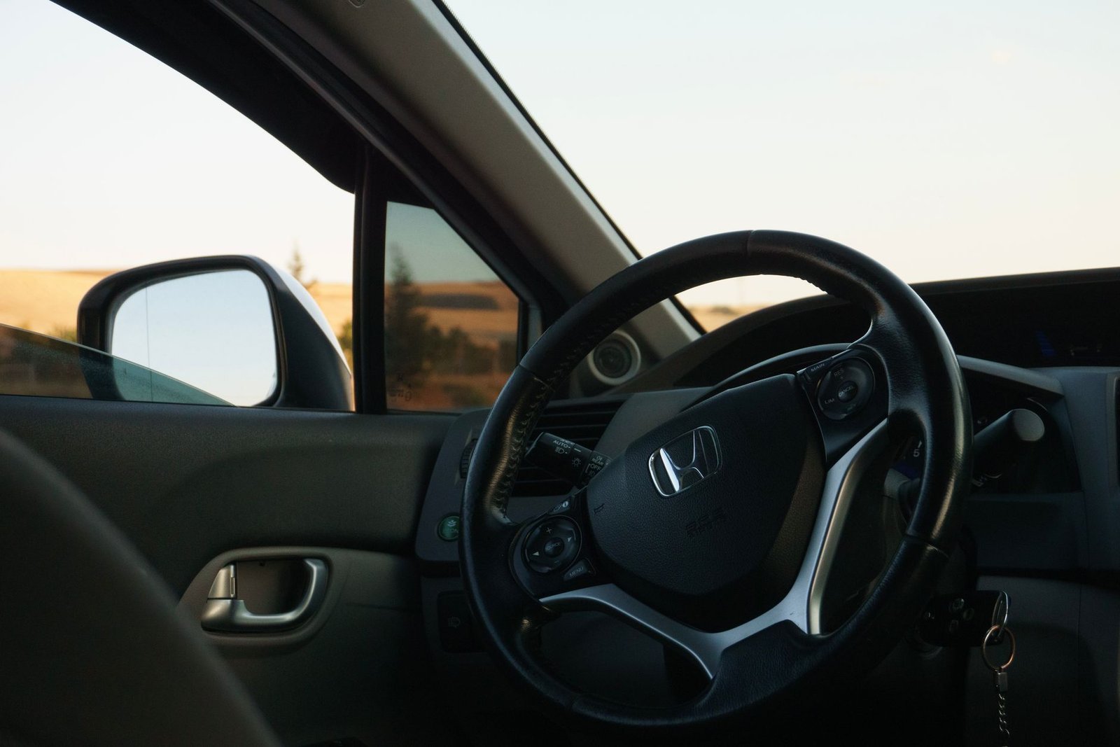 the interior of a car with a steering wheel and dashboard